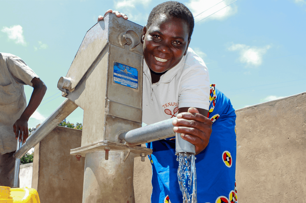 Enelesi standing by water tap