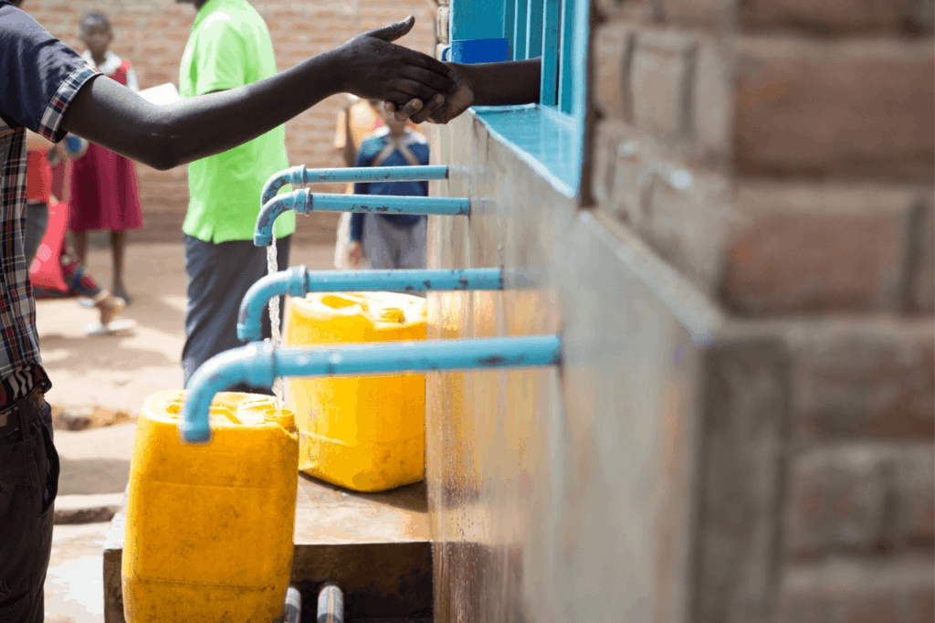 Person purchasing water from a community vendor